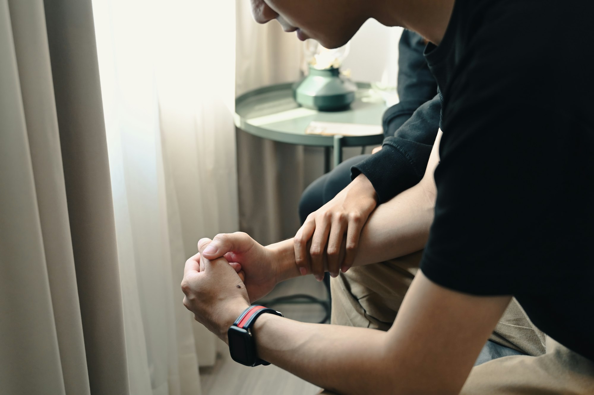 Depressed asian man with psychologist in medical clinic.