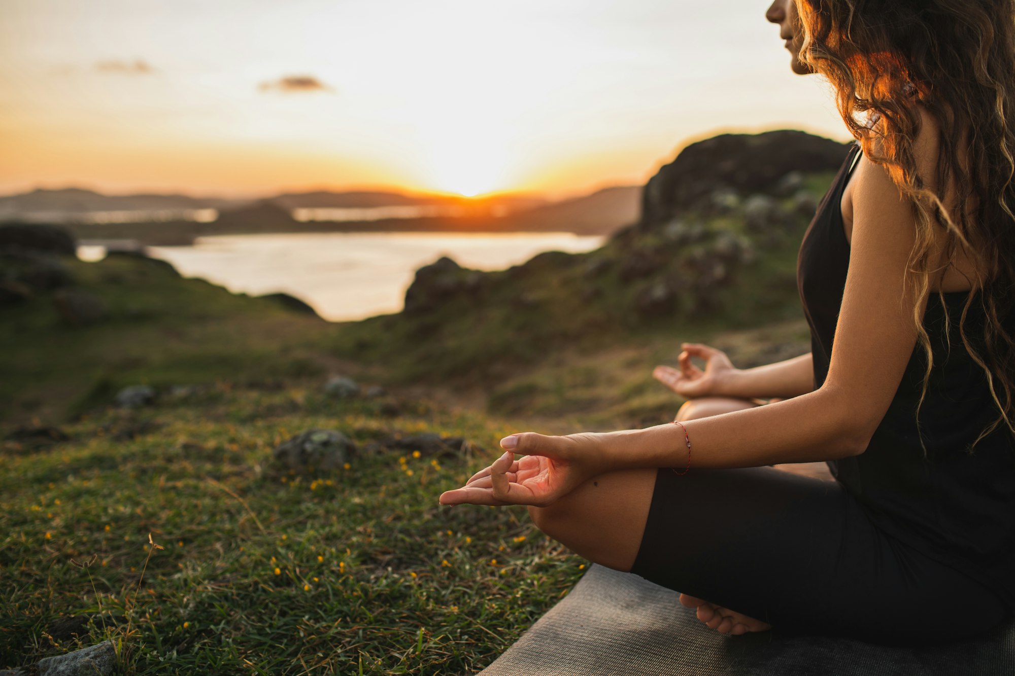 Healthy Lifestyle and Yoga Concept. Close-up hands. Woman do yoga outdoors at sunrise