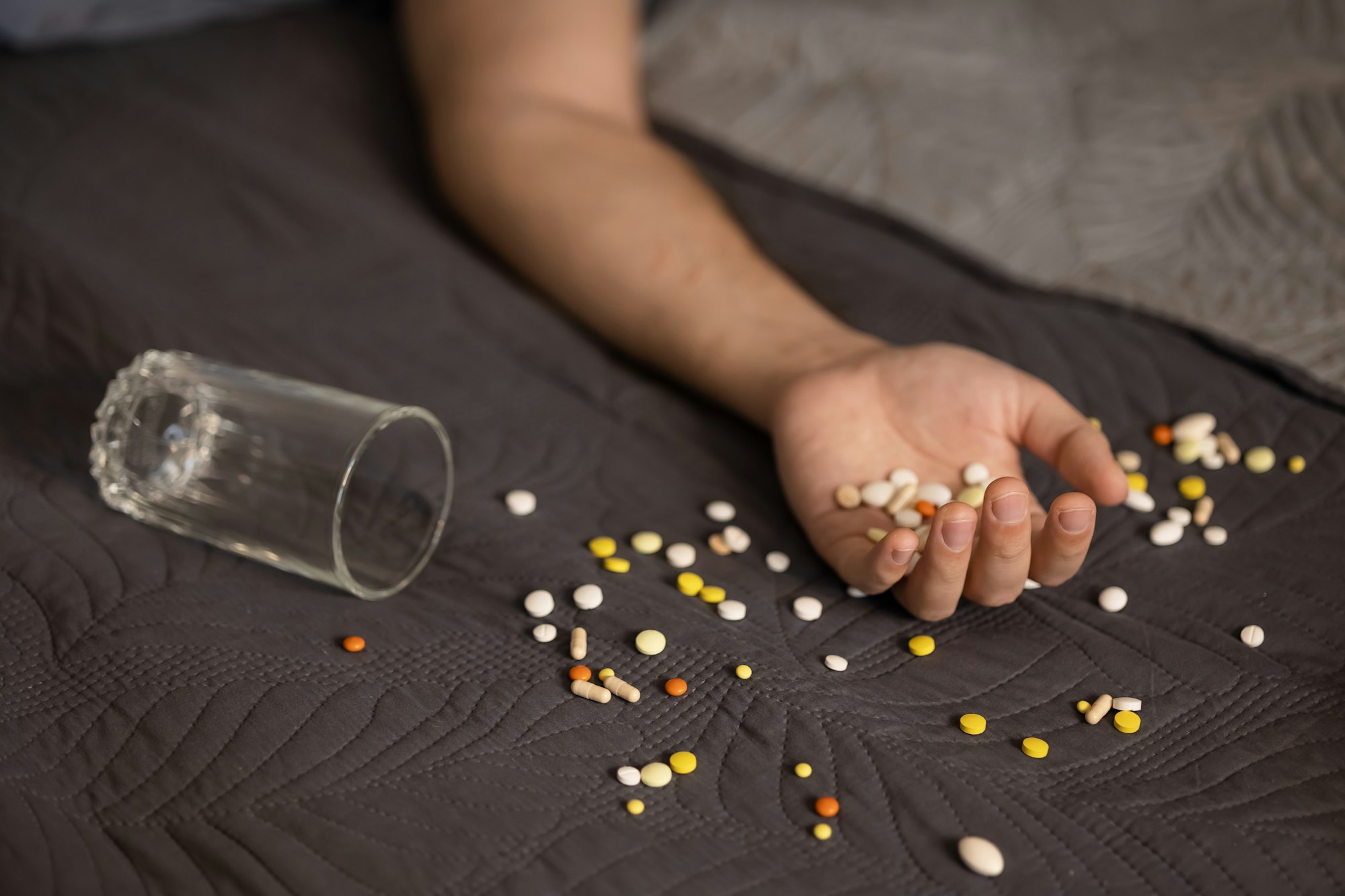 Suicide attempt, male hand with pills